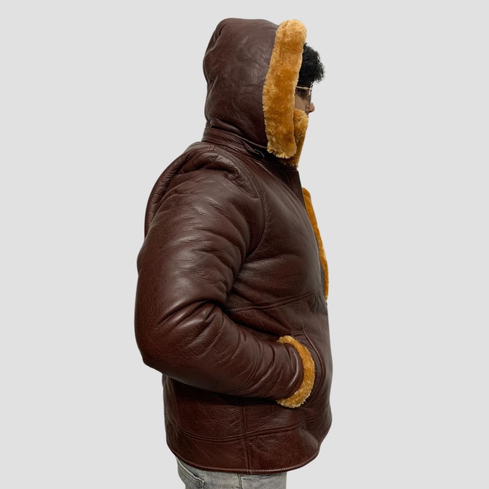 Stay warm and fashionable this winter with this sleek leather jacket, designed with shearling and a plush fur hoodie.