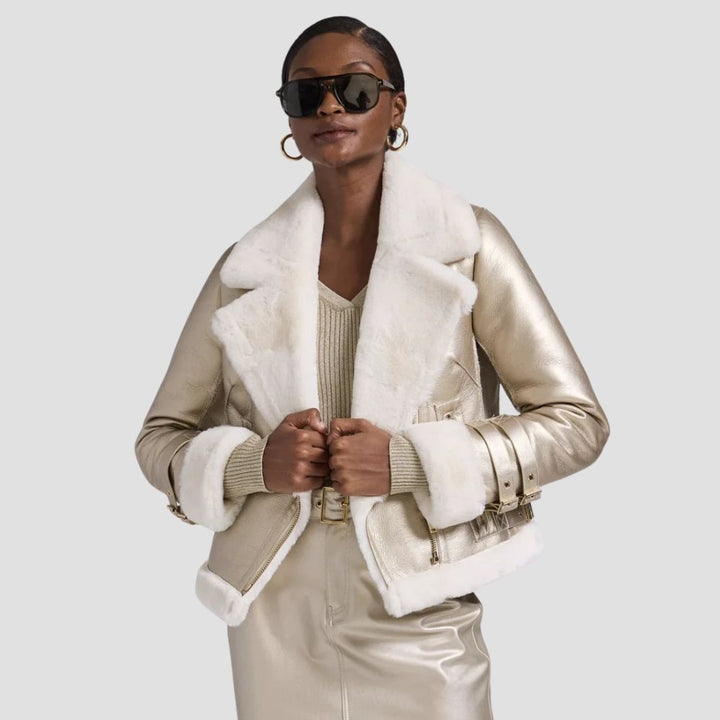 Shop a soft-touch women’s fur leather metallic jacket. This chic outwear features a luxurious fur lining and metallic leather for a bold, stylish winter look.