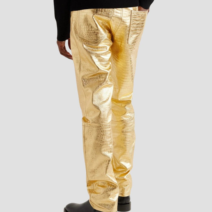 Men’s gold leather pants with crocodile embossing for a bold, luxurious style.