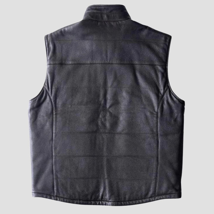 Elevate your fashion game with this sleek black leather vest, complete with a cozy fur interior.