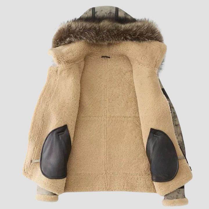 Perfect for winter outings, this jacket combines rugged leather with a plush shearling interior and fur hoodie for maximum comfort.