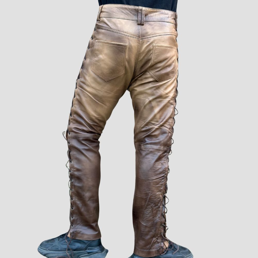 Men’s biker-style distressed leather pants with bold side laced detailing.
