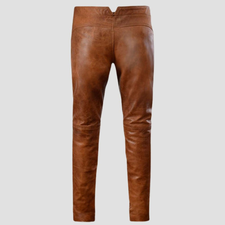 Casual wear brown distressed leather pants with a rugged look and sheepskin material.