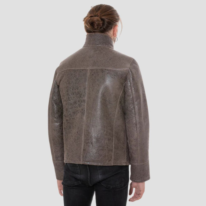 Stylish distressed brown leather jacket with curly brown fur for winter.