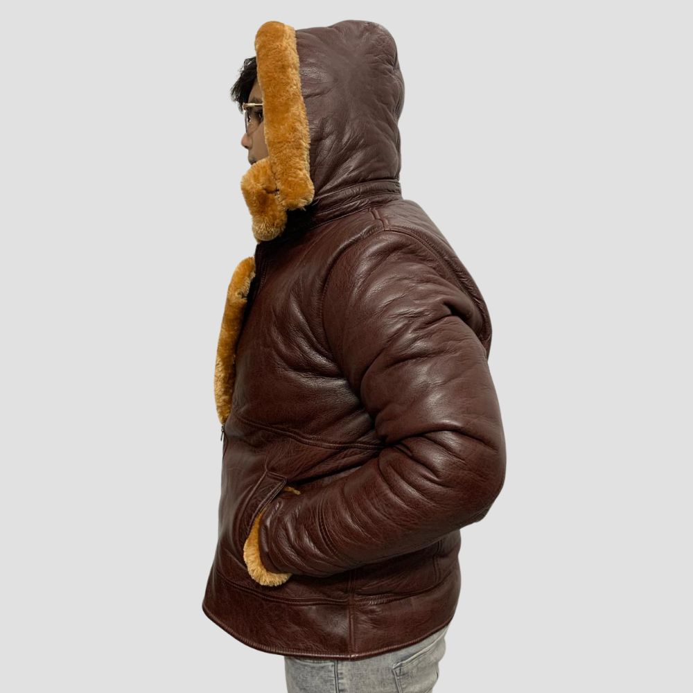 Perfect for winter, this leather jacket combines style, warmth, and functionality with its cozy shearling lining and fur-trimmed hoodie.