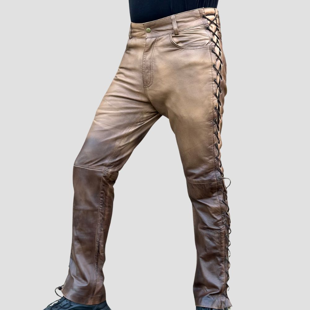 Durable vintage-style leather pants with side laces, crafted from distressed cow leather.