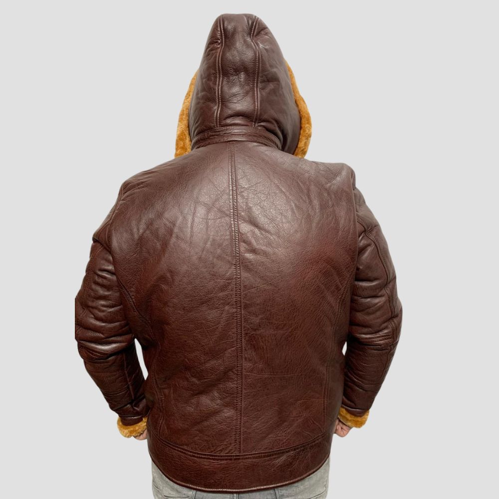 Upgrade your winter wardrobe with this men’s leather jacket featuring a cozy shearling lining and a functional fur hoodie.